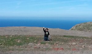 Man waving in open landscape